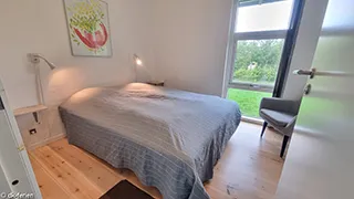 Schlafzimmer in Tjørne Mosaikhus